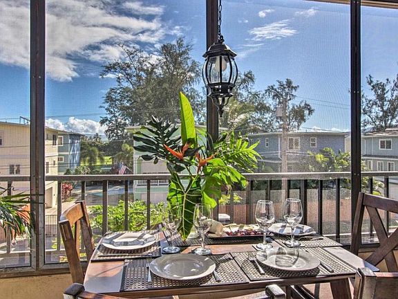 Enclosed lanai with dining table.