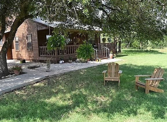 Shady trees create a canopy over the entry walkway!