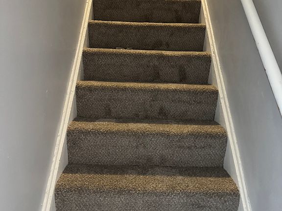 Stairway to upstairs all new paint and carpet throughout house