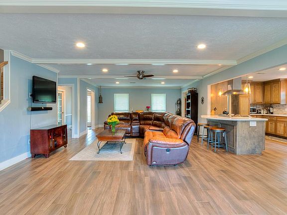 A view from the sliding glass doors. The front door opens to a hall with the study, master bedroom and bath and large closet under the stairs.