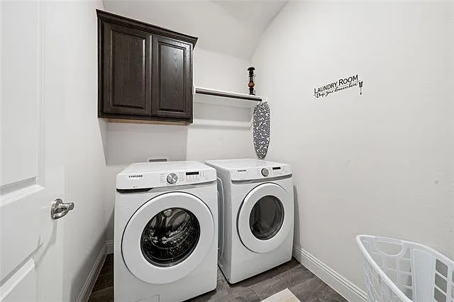 Spacious laundry room with washer, dryer and storage area