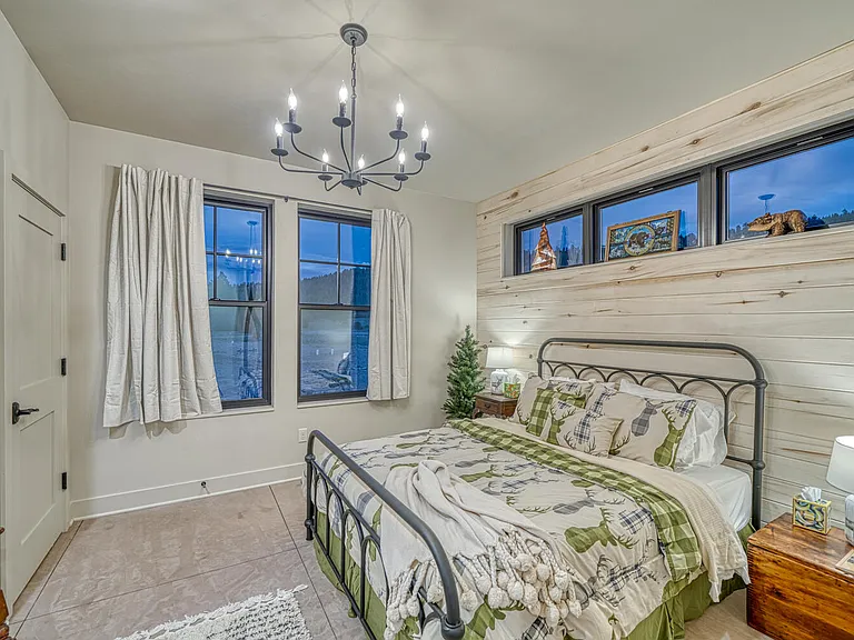 Pine Tree Room with queen bed, sitting area and closet. Adjacent bath in the hall.