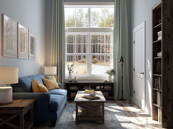 right and inviting living room with warm LVP flooring, a large picture window with natural light, and an open 15x12 layout perfect for relaxing or entertaining.