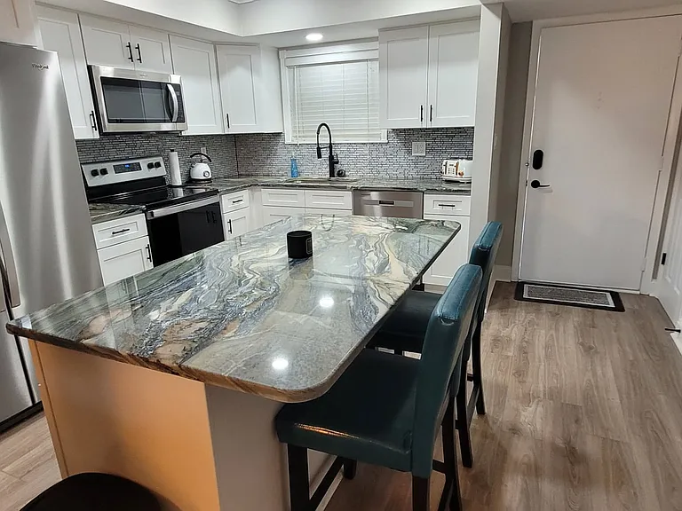 View of the completely renovated kitchen with new appliances and custom cabinets and kitchen island.