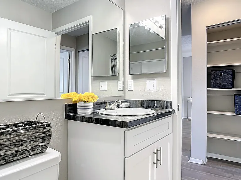 Our modern bathrooms offering a serene and stylish retreat including expansive mirrors and bright lighting.