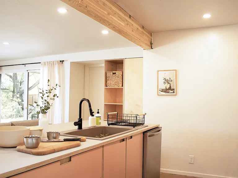Modern kitchen with island, dishwasher, and open layout.
