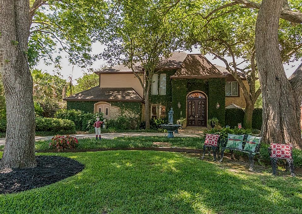 Stunning classic beauty.  Mature trees, fountains and lush landscape welcome you into this home.