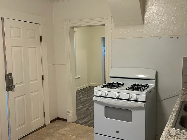 Kitchen from hallway. Outside door on left to back porch.