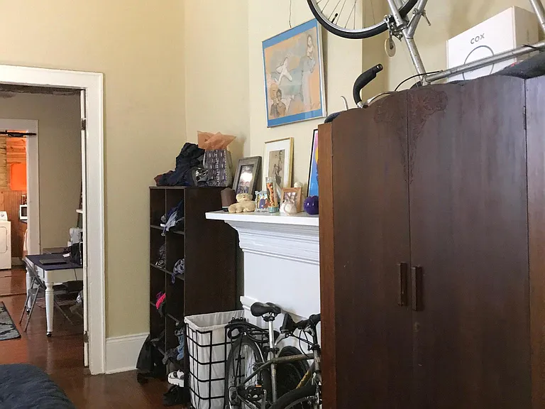 1st bedroom with pocket door and antique armoire
