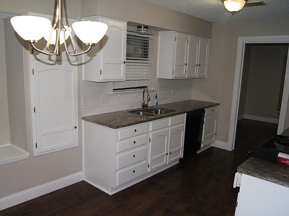 Open Kitchen with black appliances and windows galore