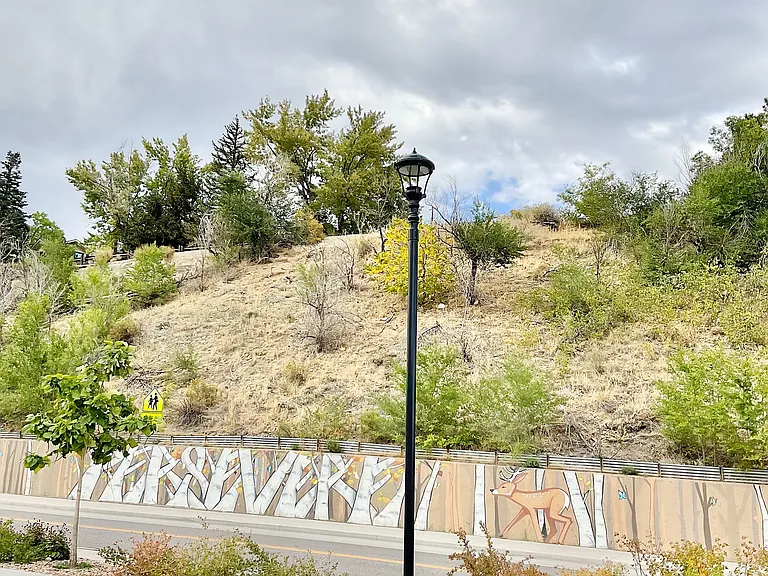 Experience tranquility with this scenic hillside view, complemented by an artistic mural.