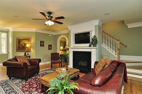 Hardwood floors, upgraded moldings and a fireplace complete the family room.