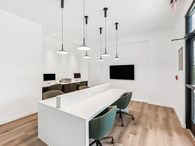 Business Center: Desks with outlets, computers, and TV