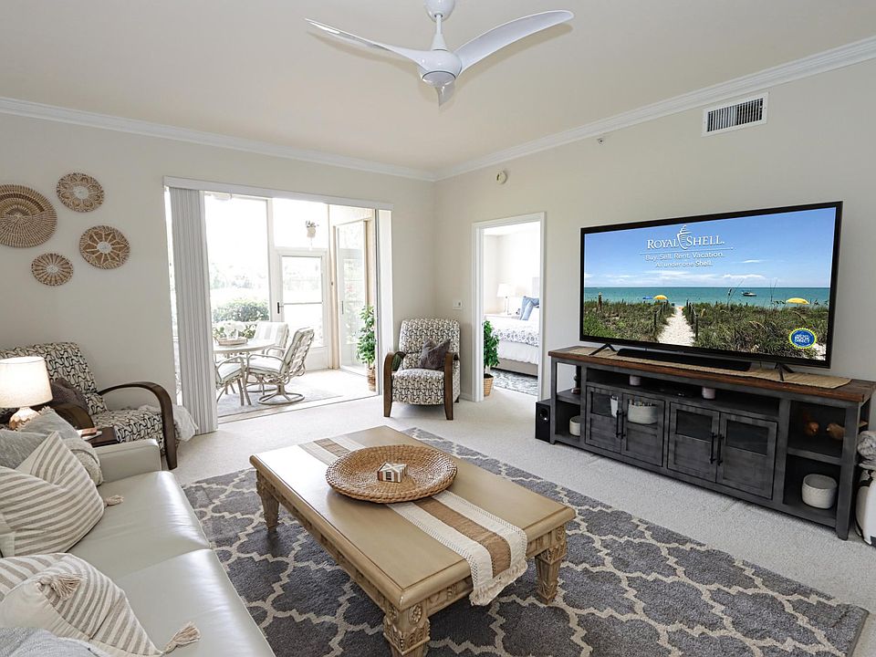Spacious living area w/queen sleeper sofa, large TV, and small built-in bar ... This area can be expanded into the enclosed back lanai by opening the sliding stacker doors.