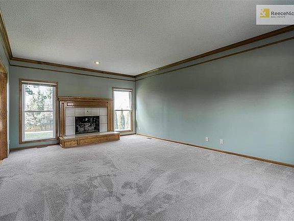 Large Great room featuring fireplace and entrance to kitchen area.