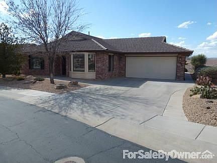 Front view
						:
						Shows the extra-length driveway, 2-car garage, front room windows & front door.
