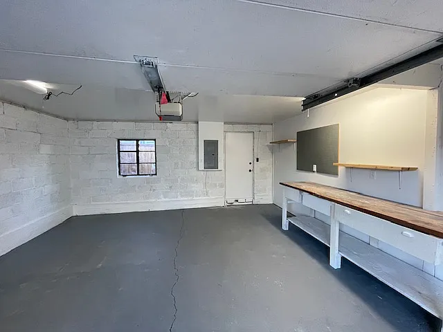 Garage studio with separate entrance in the back to the private yard/patio. View from the auto roll up garage door with opener.