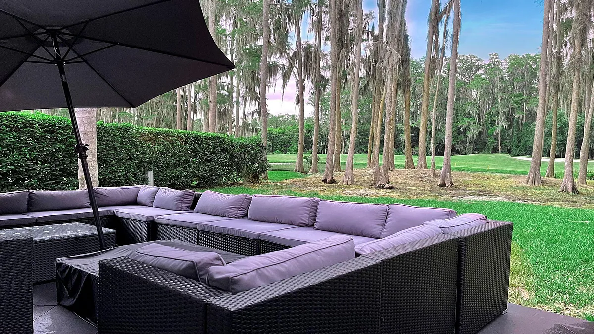 Back garden with outdoor living room style patio area overlooking lake and Saddlebrook Golf Resort Course. - 5024 Saddlebrook Way