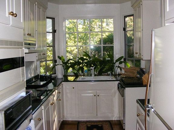 15x7 galley style kitchen with granite counters, chef's sink and bay window.