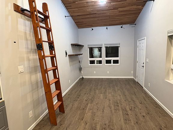 living space and front door - ladder for access to the loft.
