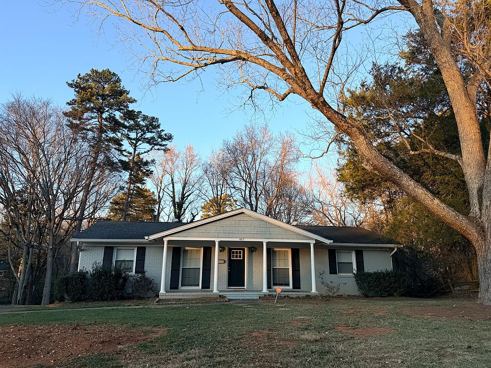 Street view of the home. The front left tree has been removed, and the remaining trunk is currently being taken out.