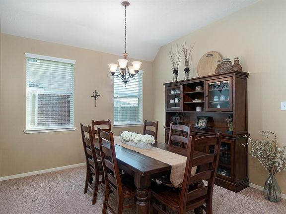 A lovely formal dining room with high ceilings and windows creates the perfect setting for formal and casual meals!