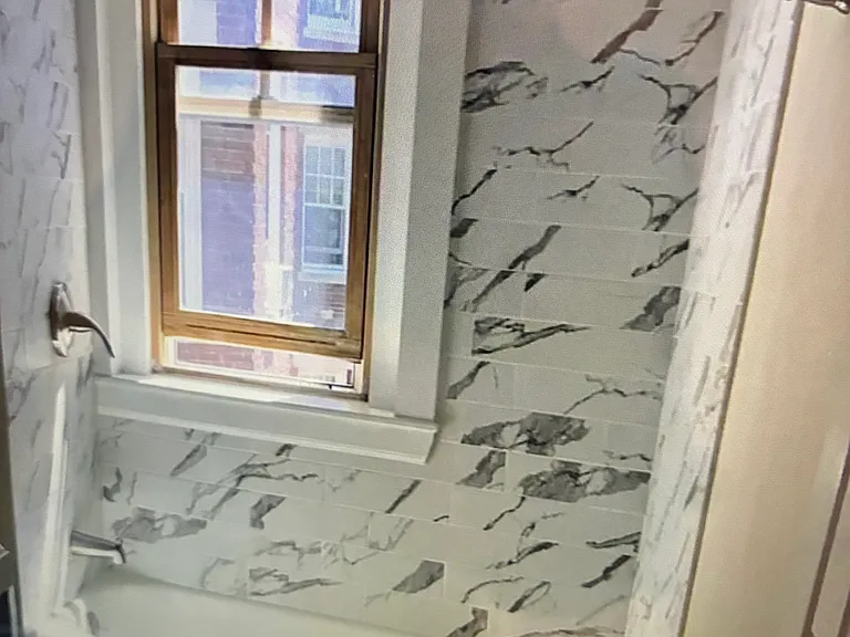 Beautiful hardwood floors flow throughout the entire floor plan of this corner unit leading to a lovely, newly tiled bathroom with a tub and shower.