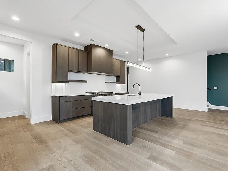 Modern kitchen with oversized island, sleek cabinetry, and clean contemporary finishes.