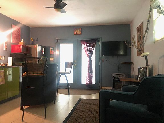 Looking from the Queen bed towards the entry way. To the left is the kitchen area....towards the right are two comfy chairs to sit in. Those two tall chairs have a glass counter to eat at or work at.