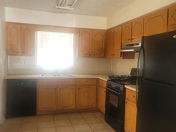 Kitchen with ceramic tile floors and appliances