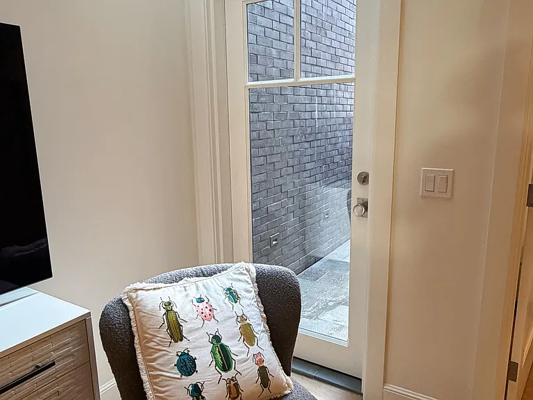 Living Room: corner showing skylight and glass back door to small private patio