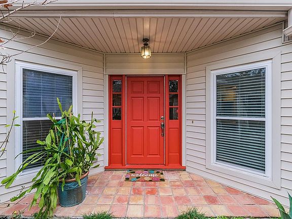 Freshly painted front door with nice overhang covering the entrance to the house.