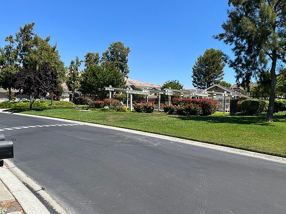 Standing at end of driveway view of pool complex entrance across the street.