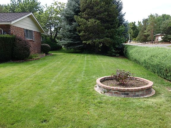 View of the two car garage and the front yard
