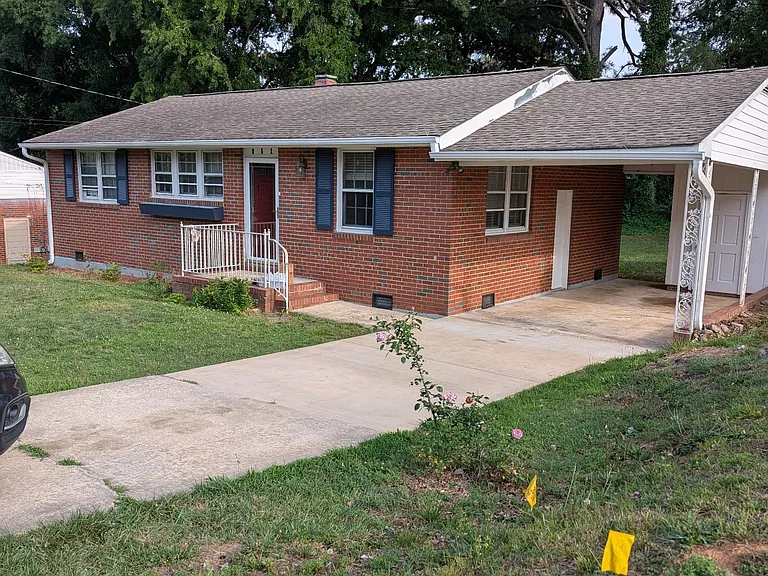 All brick ranch with carport and storage shed.