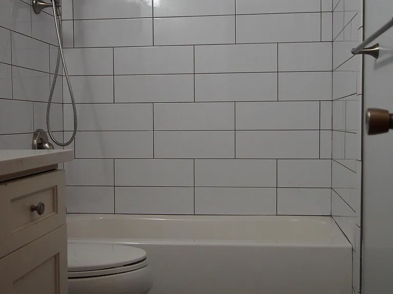 Main bathroom - new tub, tiled surround and toilet