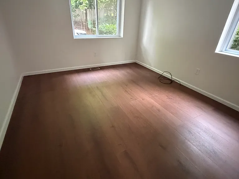 Sun drenched bedroom with brand new flooring, paint & recessed lighting. Mirrored Double door large closet
