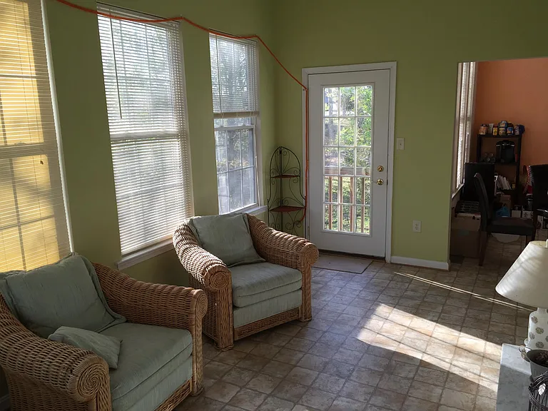 Sunroom in the back of the house viewing the forest in the back