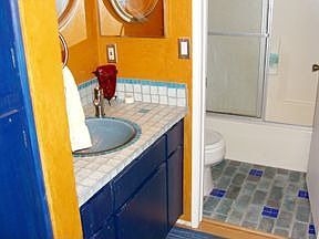 glass tile floor and counter and blue glass sink