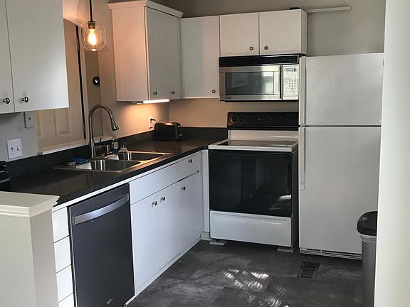 Kitchen with new dishwasher, built in microwave and door to 