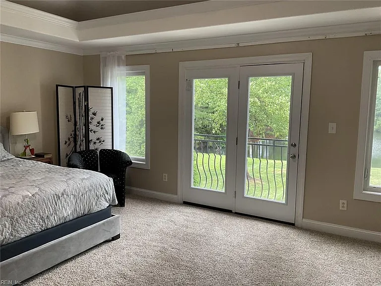 Primary double doors lead to Juliet balcony