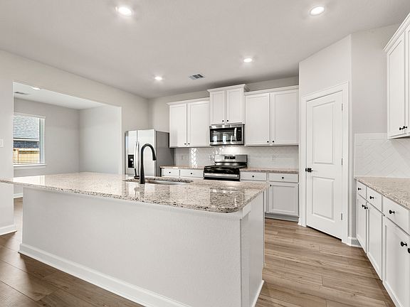 Plenty of counterspace and a large island are featured in the kitchen
