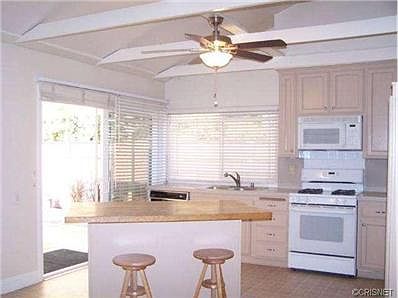 Additional Kitchen view overlooking rear shade covered patio are