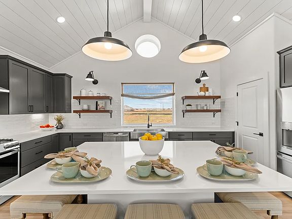 Kitchen with vaulted ceiling and pendant lighting