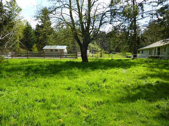 View of barn and back of house from front pasture