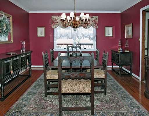 A spacious formal dining room featuring gorgeous hardwood flooring.