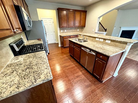 The kitchen has a lot of cabinets, counter tops and stainless steel appliances. Right off kitchen is a storage closet and walk in pantry. Dining area is open in kitchen.