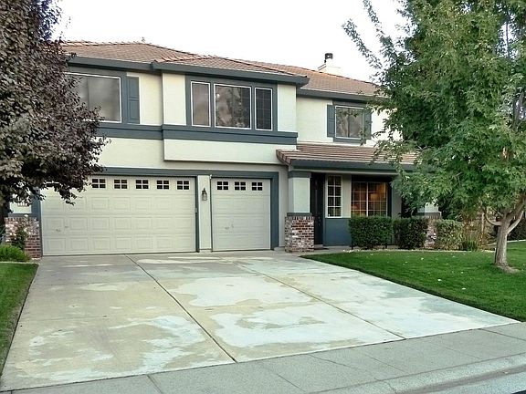 Front of house with deep driveway