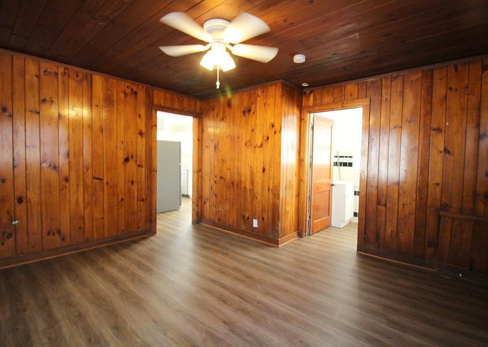 Living Room with New Flooring, Knotty Pine Walls/Ceiling, and Ceiling Fan