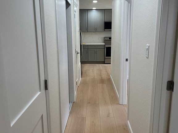 Hallway with extra closet space. Linen closet with shelves, full hanging clothes closet and furnace closet with some storage area. New doors all throughout.